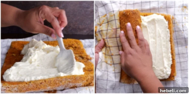 Spreading cream cheese filling onto the unrolled pumpkin cake and then carefully re-rolling it into a neat log.