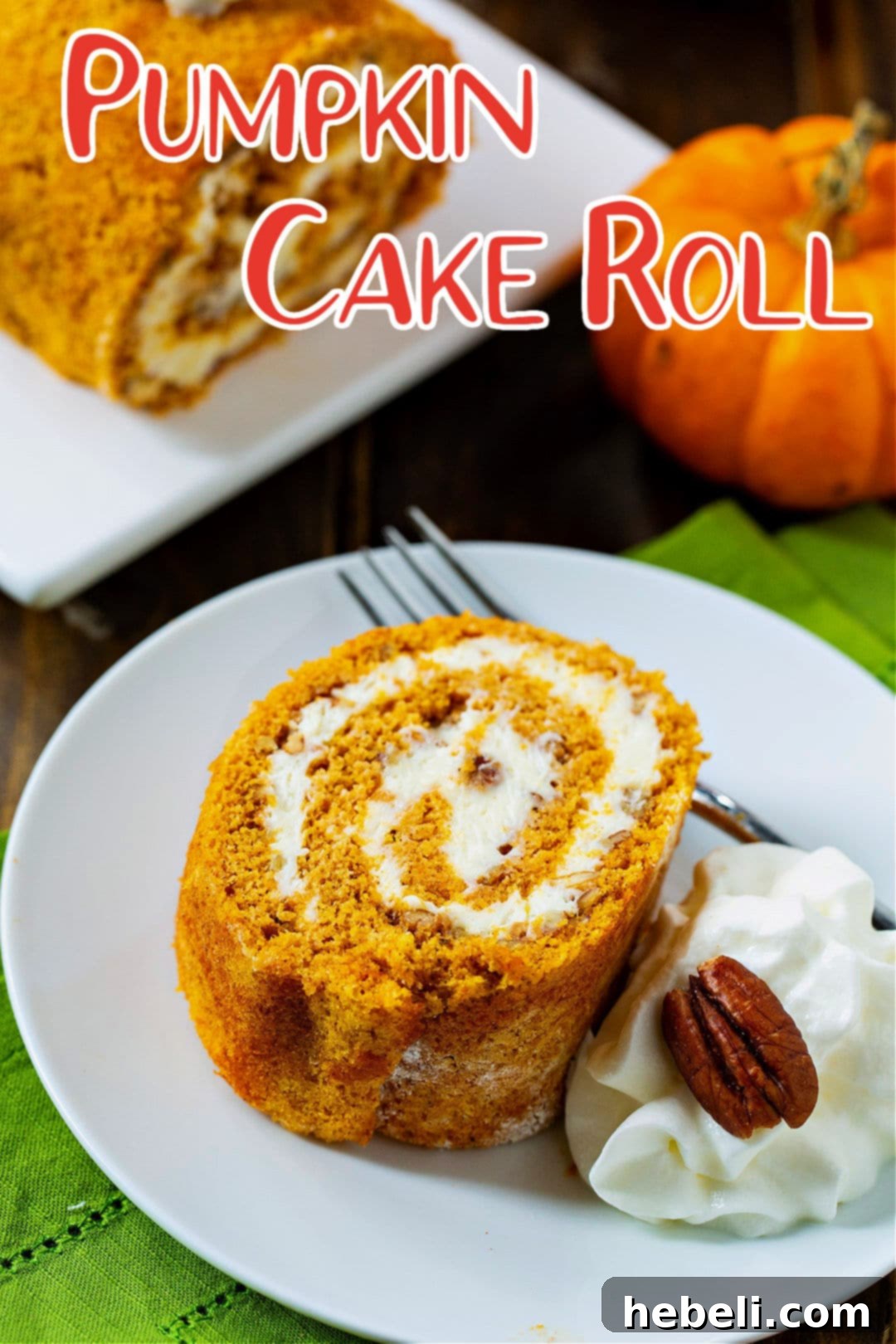 A close-up of a single slice of Pumpkin Cake Roll adorned with whipped cream, emphasizing its rich texture and festive appeal.