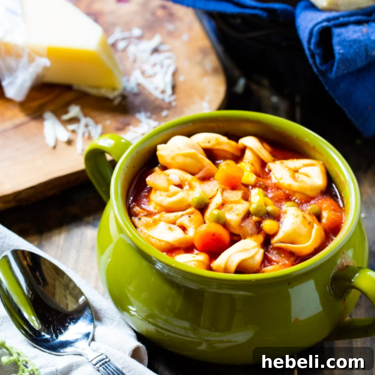 A steaming bowl of Easy Tortellini Soup, garnished with fresh herbs, ready to be enjoyed.