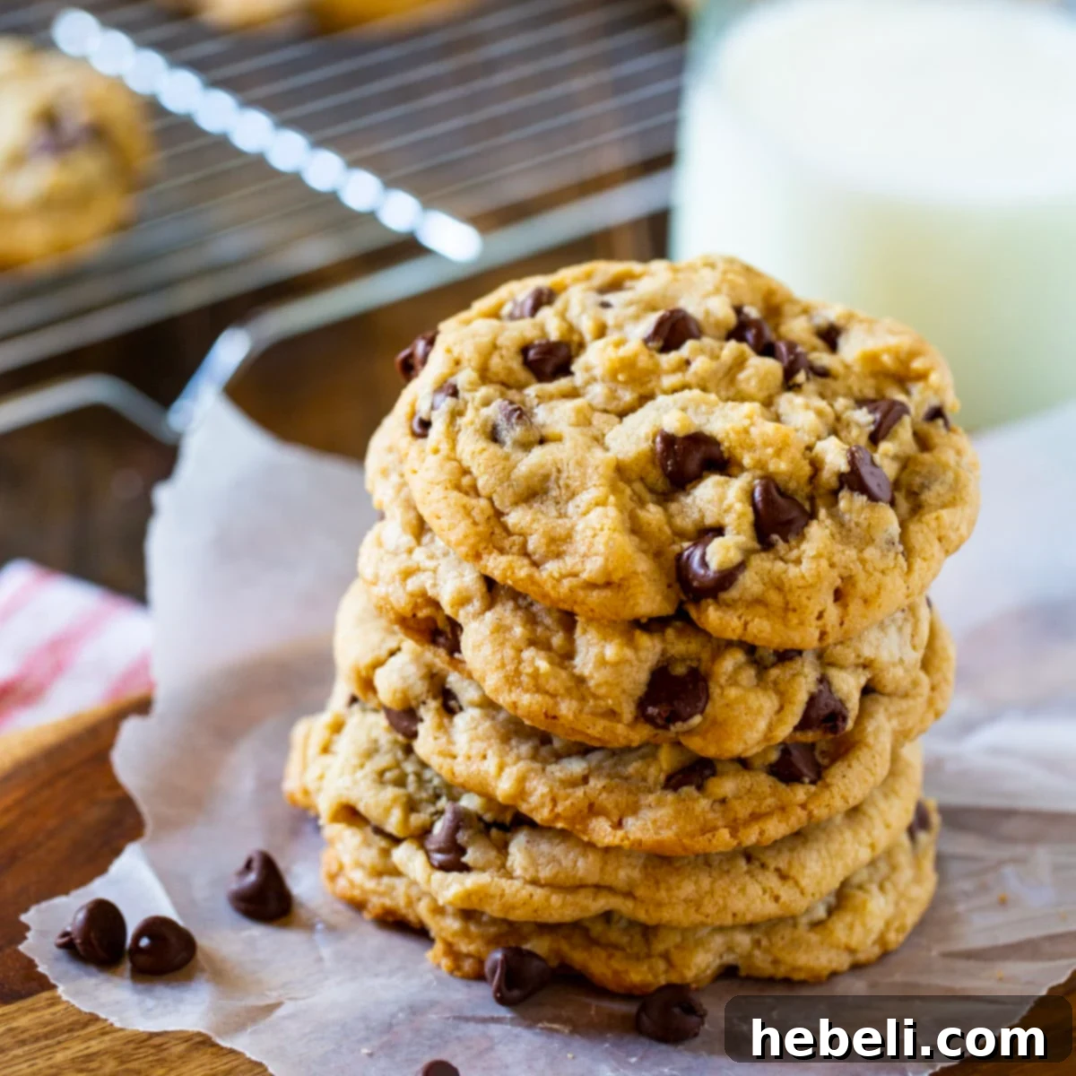 Perfectly Chewy Chocolate Chip Cookies 2 Stack of freshly baked chewy chocolate chip cookies with a rich, golden-brown hue and visible melted chocolate chips.