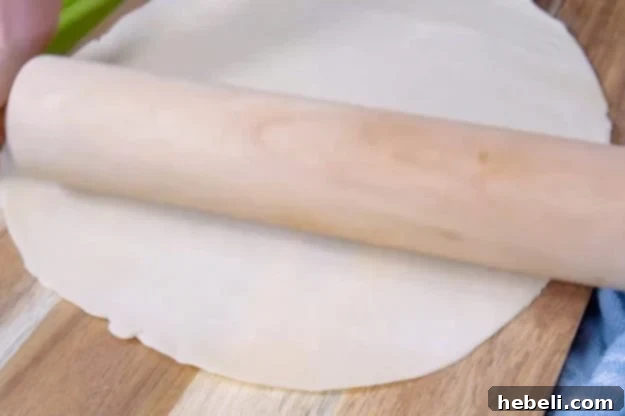 Rolling out refrigerated pie dough for turnovers.