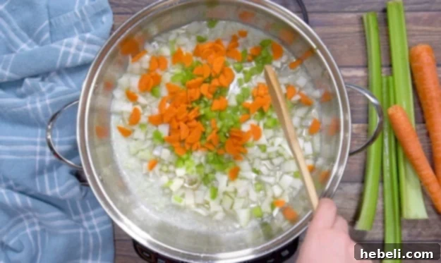 Cooking the carrots, onion, and celery in a skillet.