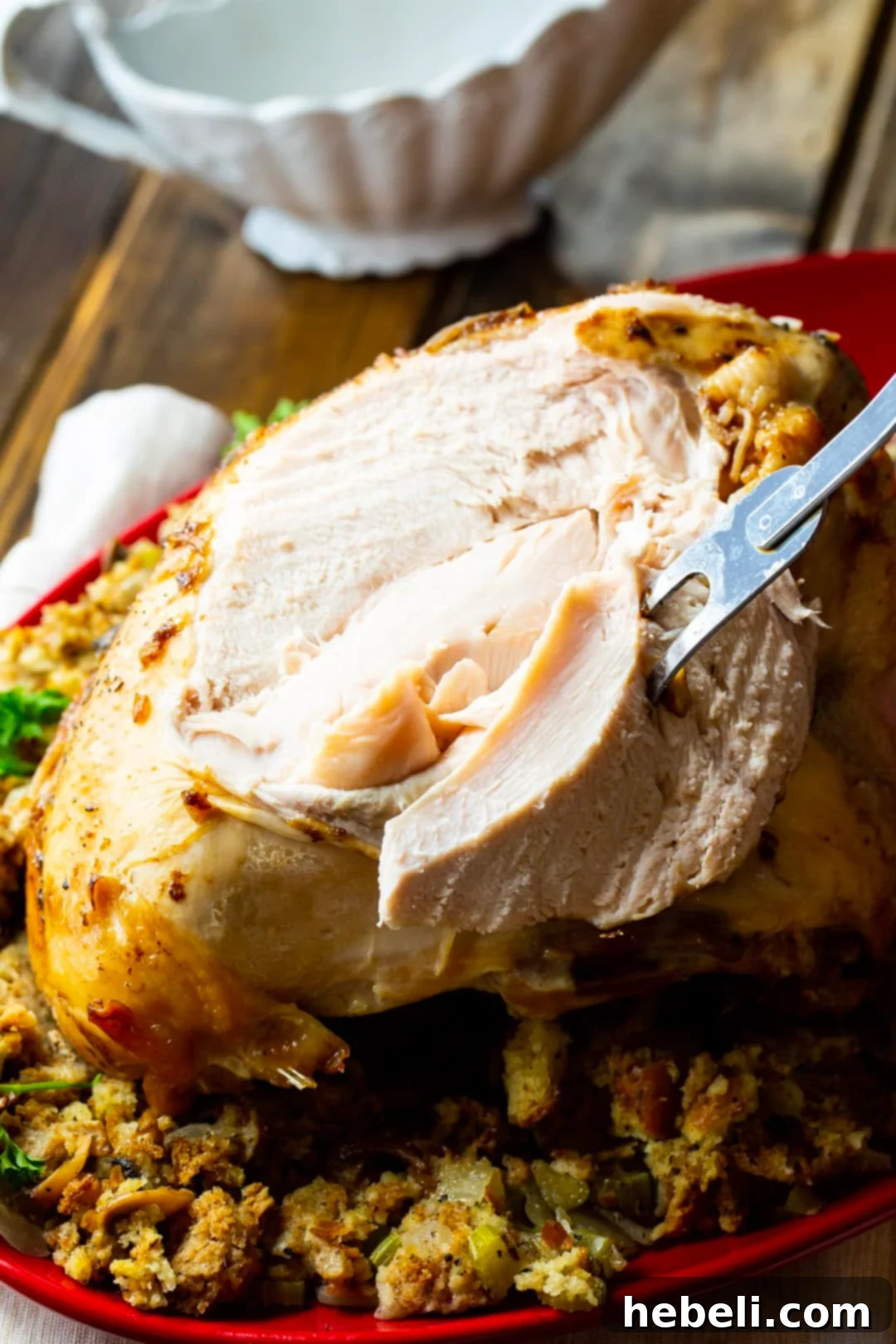 Juicy Slow Cooker Turkey Breast 4 Close-up of a succulent turkey breast with a single slice removed, showcasing its tender texture.