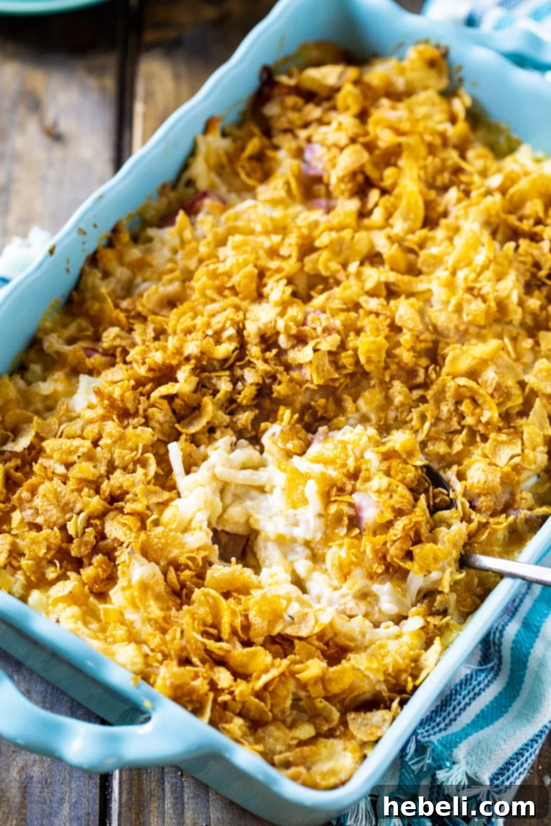 Funeral Potatoes with Ham in blue casserole dish.