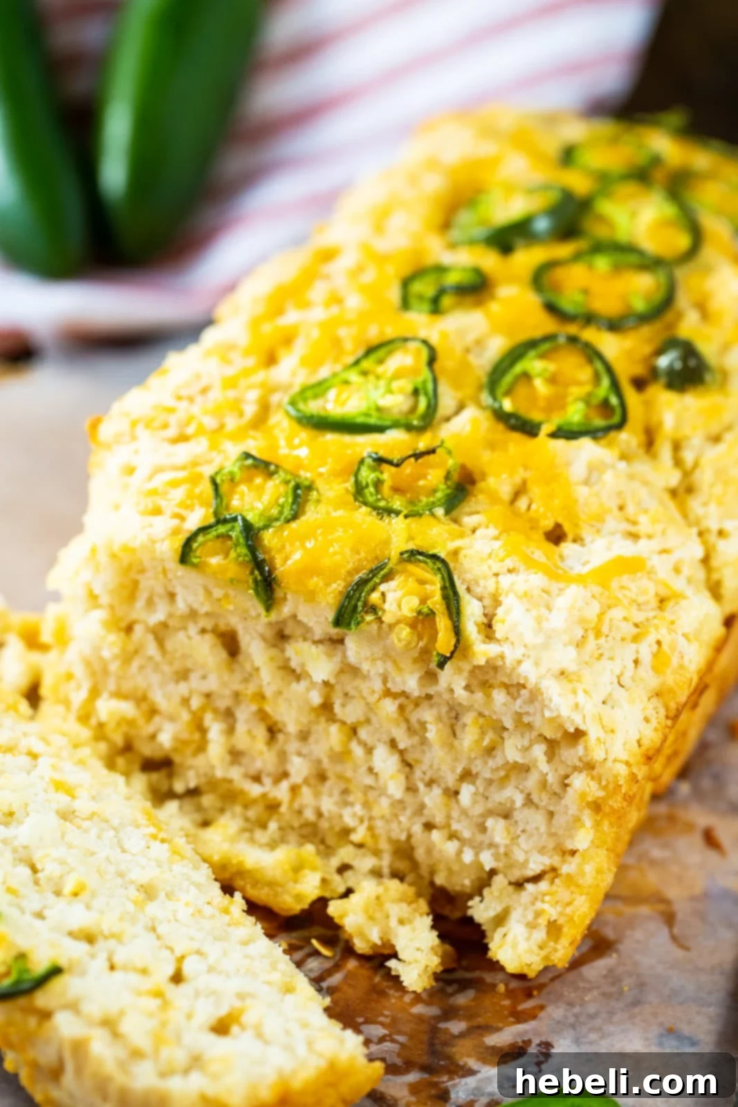 Beer Bread with sliced jalapenos and shredded cheddar cheese on top, ready for baking.