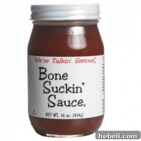 A bottle of Bone Suckin' BBQ Sauce, a key ingredient for the perfect Brunswick Stew flavor.