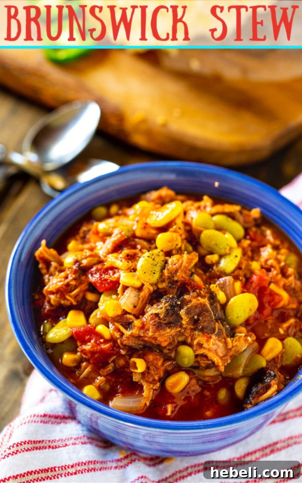 A close-up of a rustic blue bowl filled with Easy Brunswick Stew, showcasing its rich texture and ingredients.