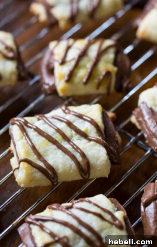 Close-up of a freshly baked Chocolate Croissant Cookie, golden brown with visible chocolate melting within