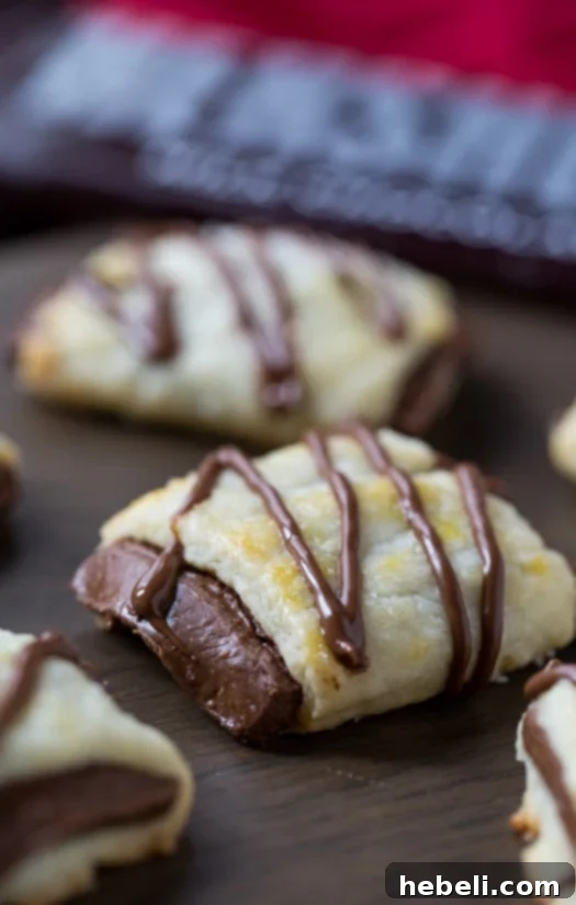 Plate of decadent Chocolate Croissant Cookies, elegantly drizzled with extra melted chocolate for a festive touch