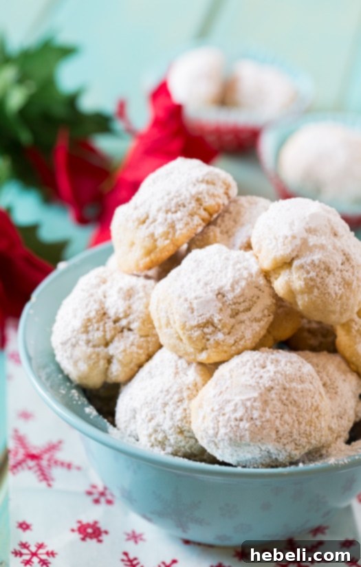 Buttery Greek Delights 4 Assortment of Greek Butter Cookies on a festive platter, covered in powdered sugar.