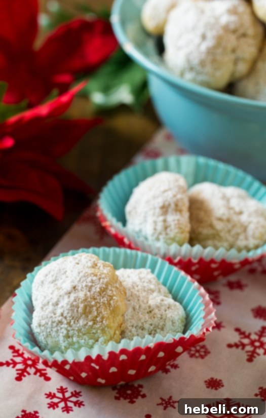 Buttery Greek Delights 5 Freshly baked Greek Butter Cookies on a wire rack, ready for dusting.