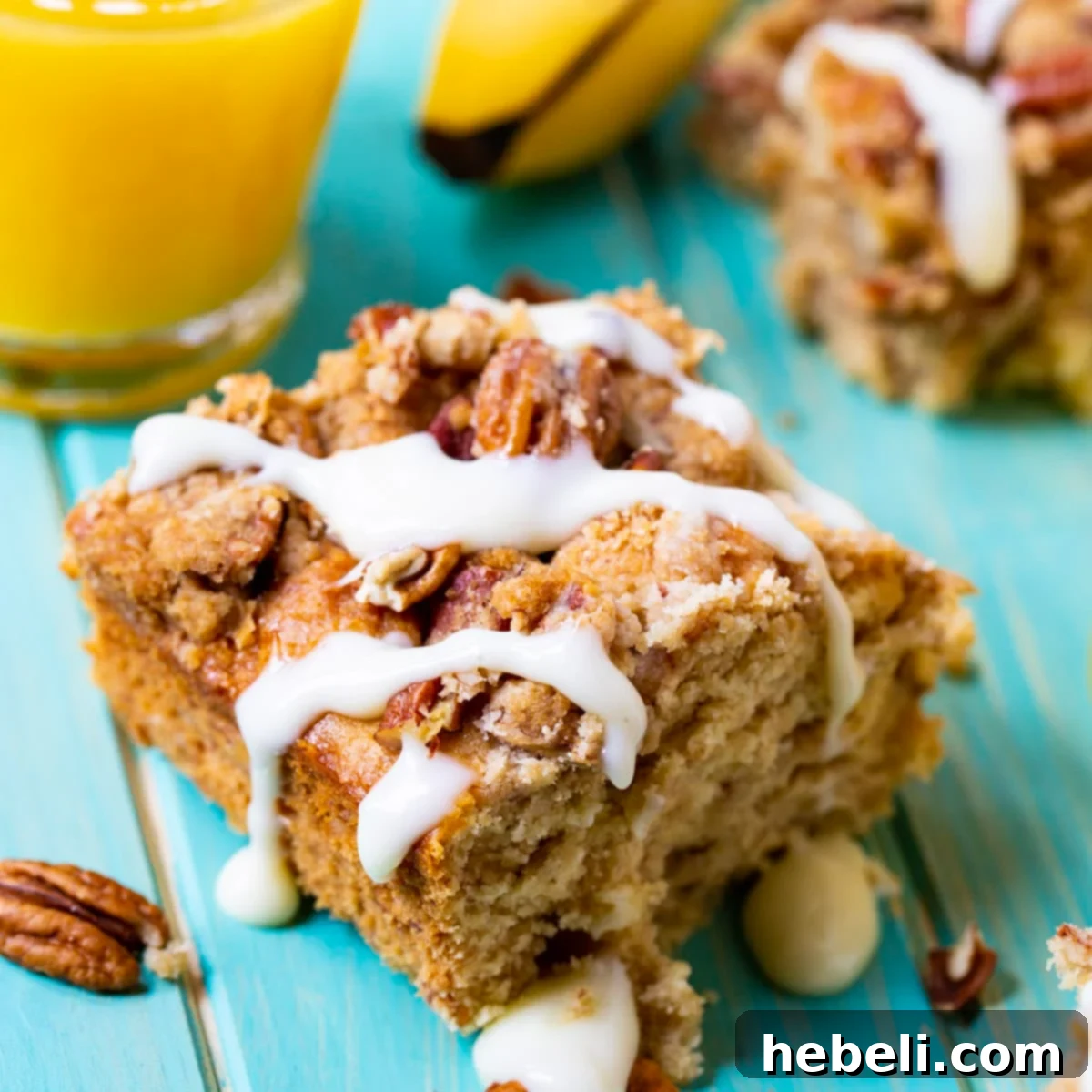 Rum Caramel Banana Coffee Cake 2 Square slice of Bananas Foster Coffee Cake, showing moist texture, streusel, and a drizzle of rum sauce.