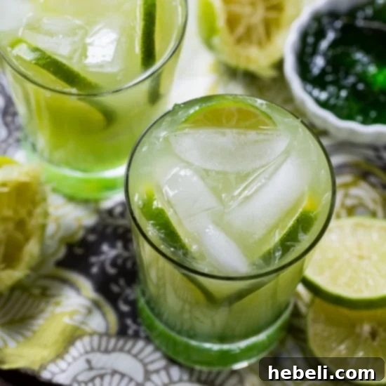 Ingredients for a Pepper Jelly Margarita laid out on a rustic surface