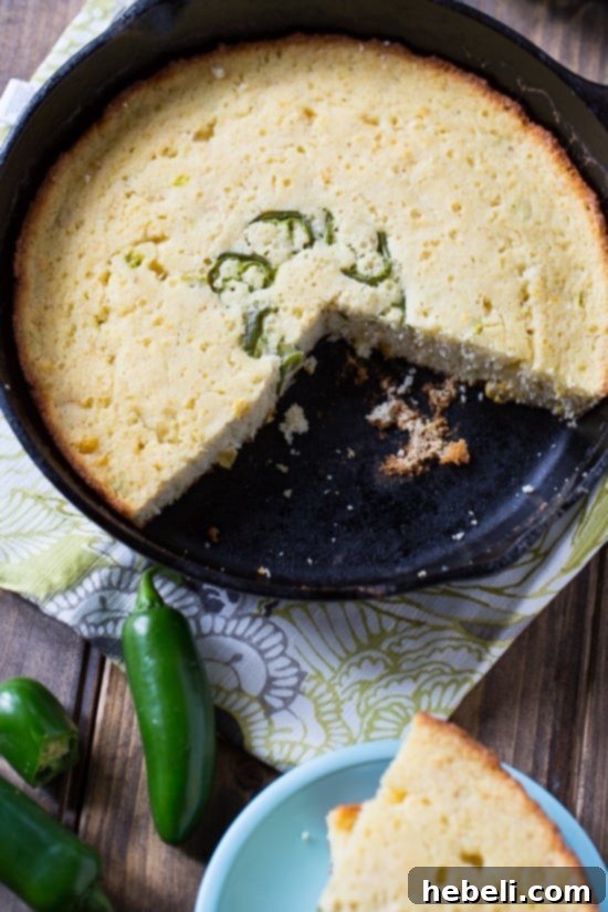 A perfectly sliced piece of Super Moist Jalapeno Cornbread on a clean plate