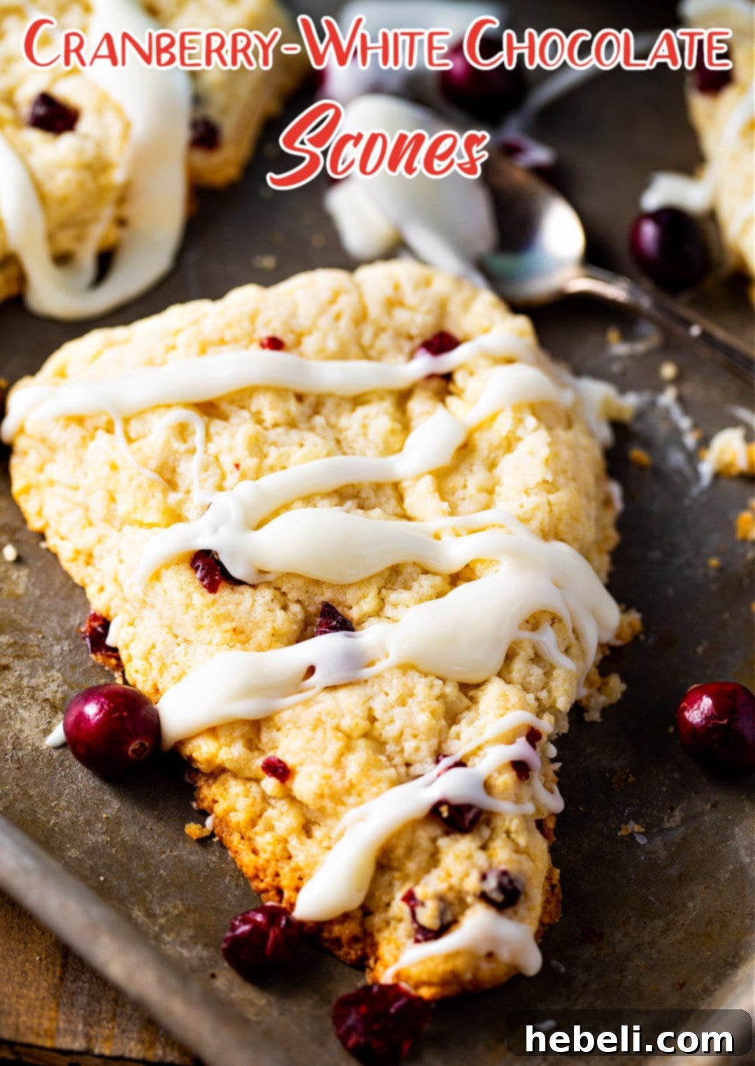 White Chocolate Cranberry Bliss Scones 4 A single Cranberry White Chocolate Scone generously covered with a smooth vanilla glaze, ready to be enjoyed.