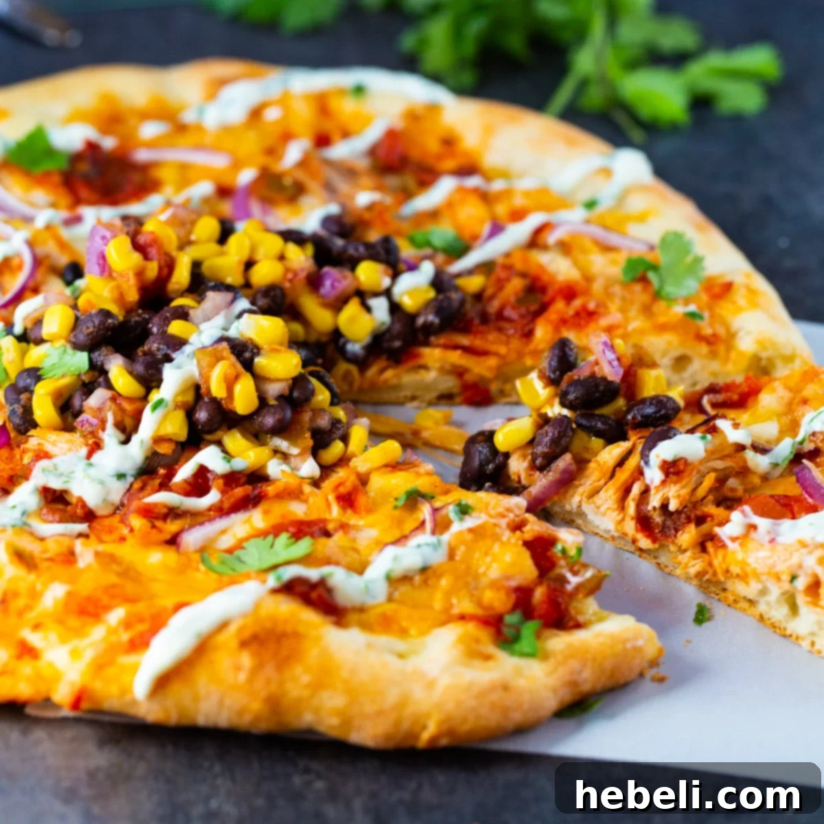 Smoky Chipotle Chicken Pizza 2 A delicious slice of homemade Chipotle Chicken Pizza being pulled from the main pie, showing melted cheese and vibrant toppings.