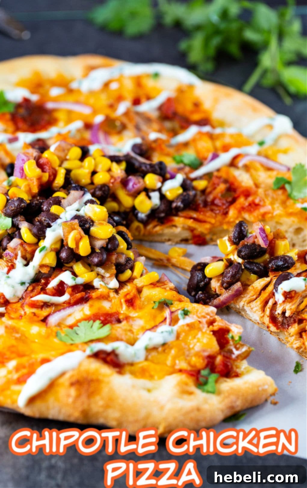 Smoky Chipotle Chicken Pizza 4 A close-up of a freshly baked Chipotle Chicken Pizza, steam rising, with a slice already removed and the golden-brown crust visible.
