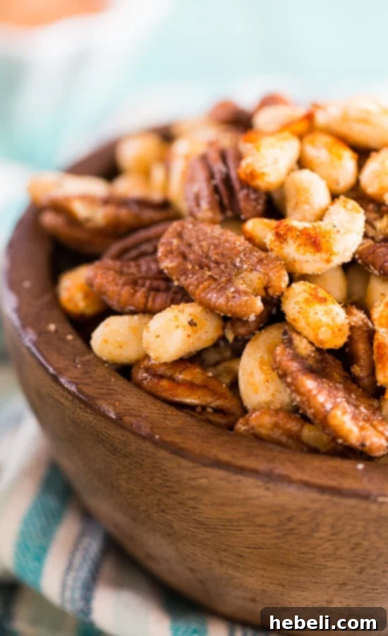 Cajun Nuts - make a great party snack. Flavored with plenty of spices, some sugar, and a little bacon grease to elevate the taste!