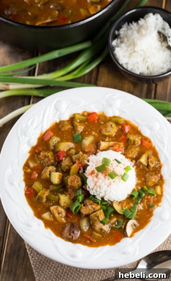 Close-up of Vegetarian Gumbo featuring a dark roux, plump red beans, tender okra, and colorful bell peppers