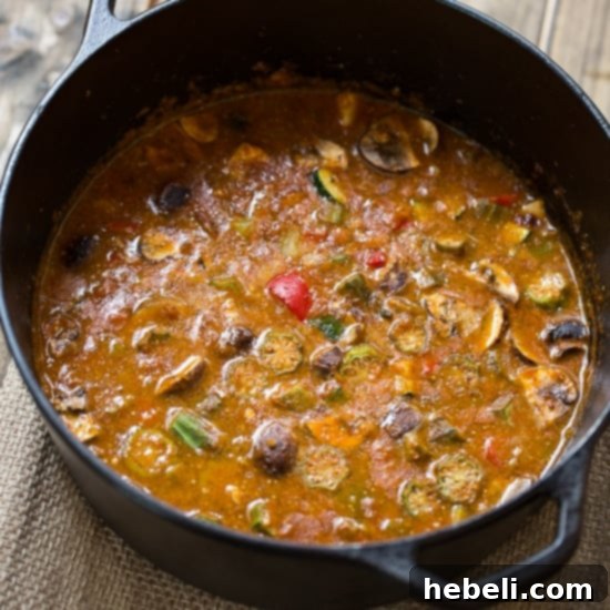 Vegetarian Gumbo simmering with various fresh vegetables including okra, mushrooms, bell peppers, zucchini, and red beans