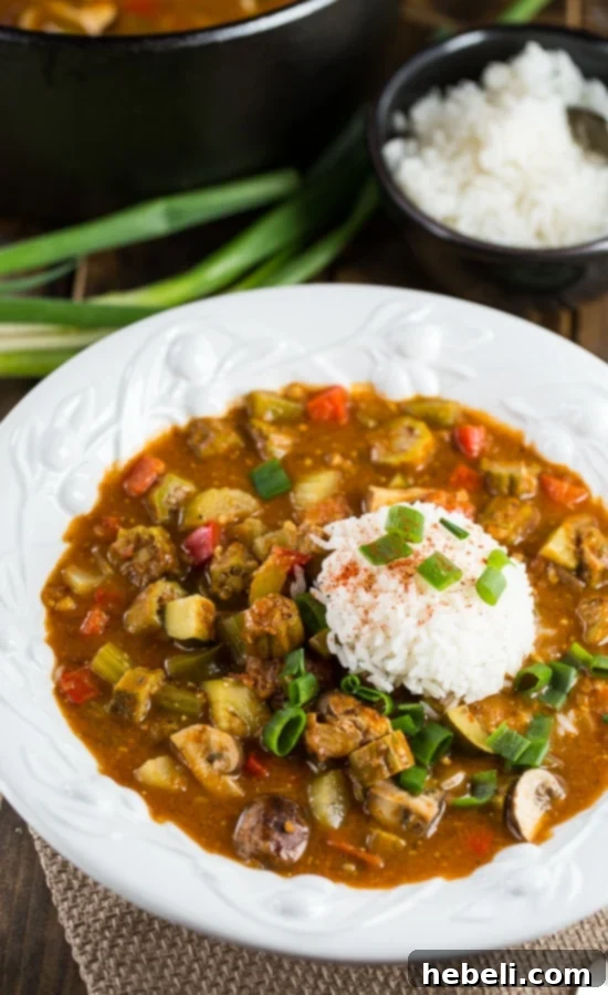 A bowl of Vegetarian Gumbo served over rice, garnished with fresh green onions