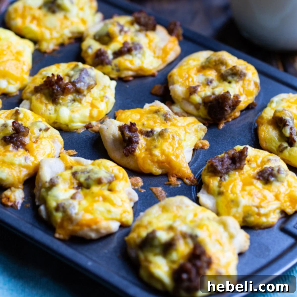 Sausage Biscuit Cups in a mini muffin tin, golden brown and ready to eat.