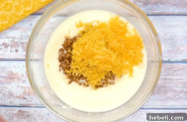 Sausage and cheddar cheese folded into the egg and cream cheese mixture.