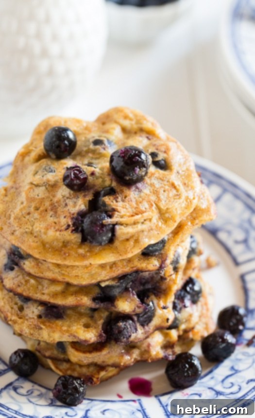 Close-up of Blueberry Almond Protein Pancakes, showing their fluffy texture and abundance of blueberries