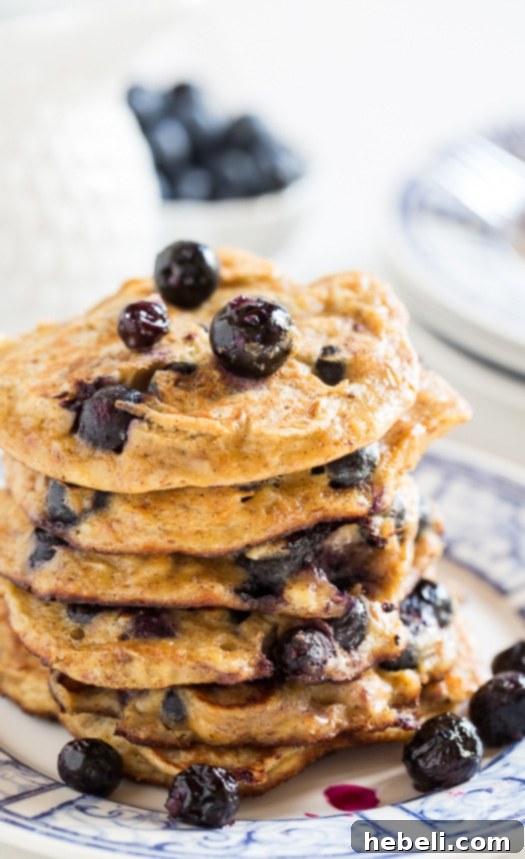 Ingredients for Blueberry Almond Protein Pancakes laid out, highlighting fresh blueberries and almond products