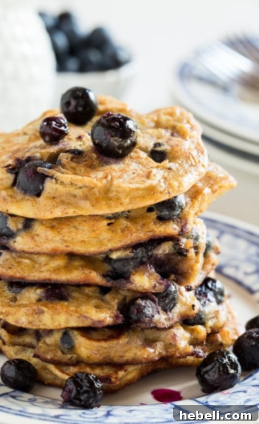 Overhead shot of freshly cooked Blueberry Almond Protein Pancakes on a plate