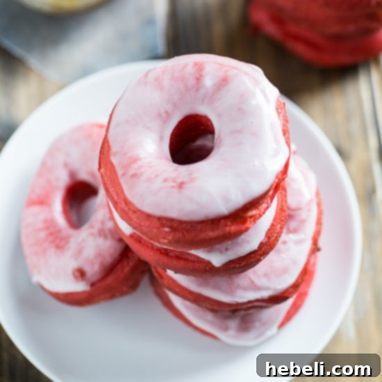Decadent Red Velvet Glazed Doughnuts 7 A beautifully arranged plate of Red Velvet Donuts with Glaze, showcasing their vibrant color and festive appeal, ready for serving.