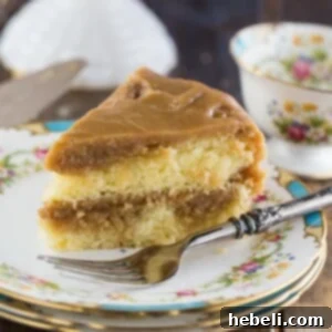 Top view of a round Southern Caramel Cake with thick frosting and decorative swirls.