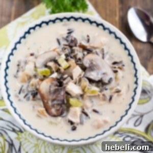 Delicious Chicken and Wild Rice Soup, garnished with herbs.
