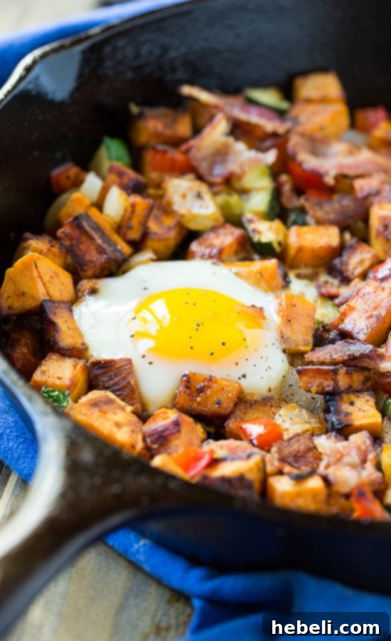 Hearty Sweet Potato Breakfast Hash 4 Cooking bacon in a cast-iron skillet, preparing for Sweet Potato Hash