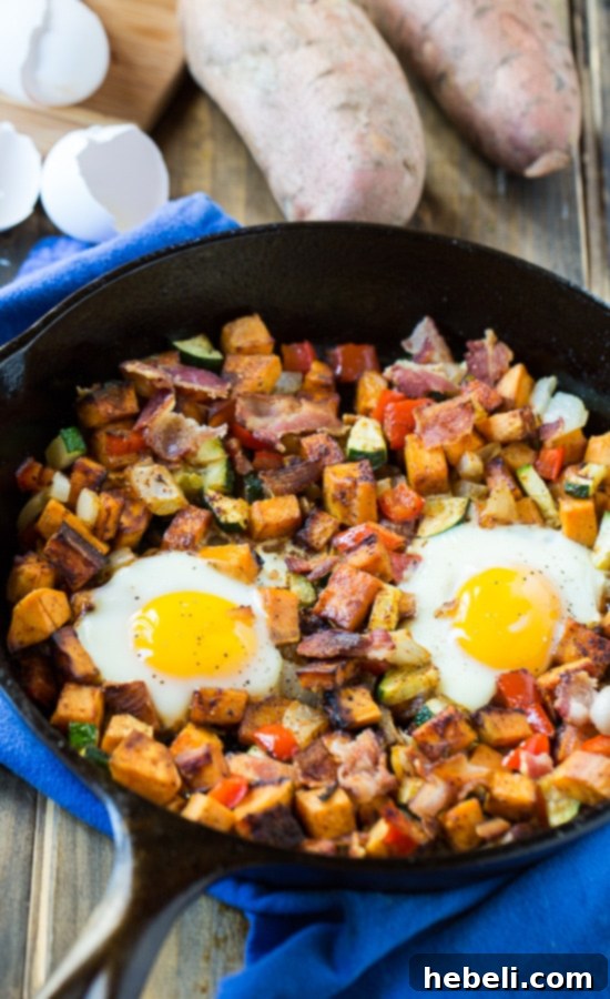 Hearty Sweet Potato Breakfast Hash 5 Sweet Potato Hash with eggs cooking in the oven, showing runny yolks