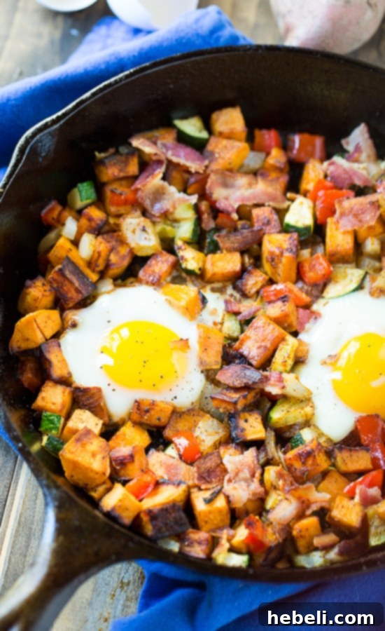 Hearty Sweet Potato Breakfast Hash 6 Close-up of Sweet Potato Hash with Eggs and Bacon, garnished and ready to serve
