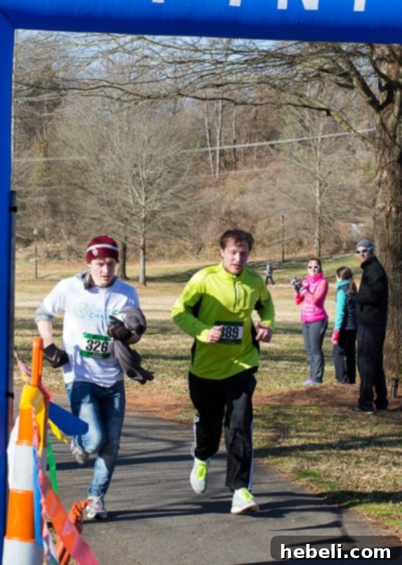 Chase crossing the finish line at Cancer Chase 5K with a friend