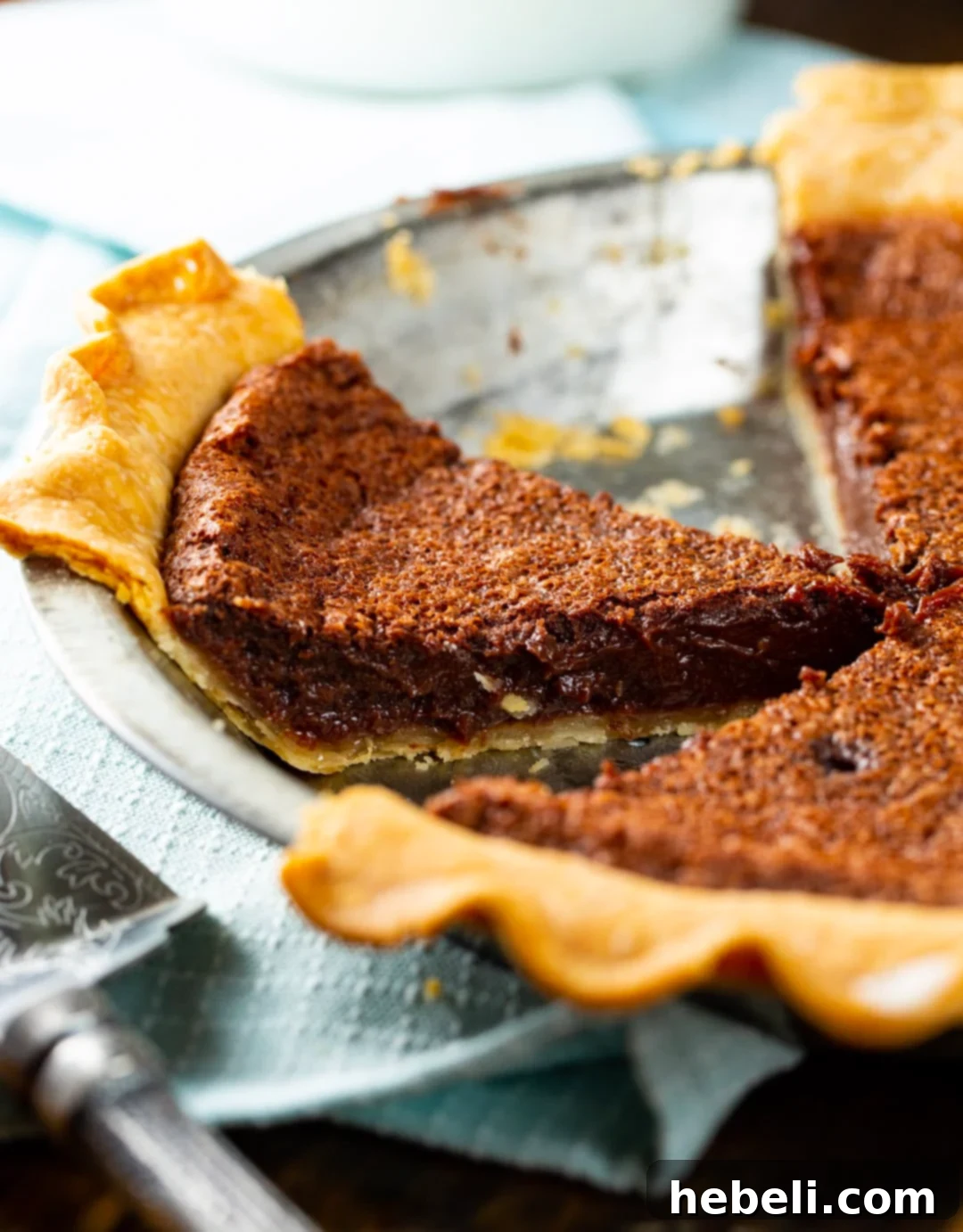 Decadent Chocolate Chess Pie 3 A whole Chocolate Chess Pie, expertly cut into uniform slices, ready for serving.