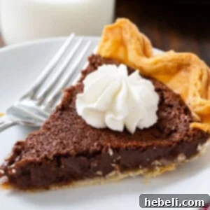 Chocolate Chess Pie slice topped with whipped cream.