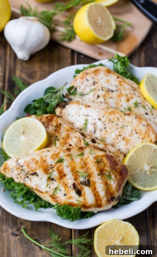 Zesty Mediterranean Grilled Chicken 3 Close-up of chicken breasts marinating in a flavorful Greek herb and lemon mixture