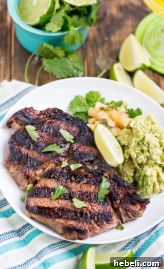 Close-up shot of raw Margarita Rib-Eye Steaks marinating in a vibrant tequila-lime mixture, showcasing the rich marbling.