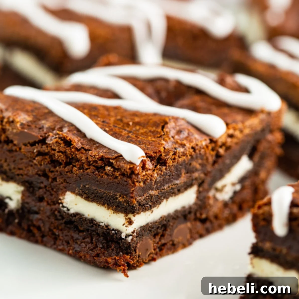 Delicious Oreo Stuffed Brownies on a white plate, showcasing their rich, fudgy texture and creamy Oreo centers.