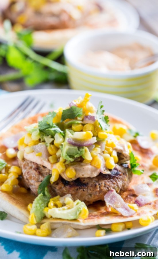 Tex-Mex Turkey Burger with a generous topping of avocado corn salsa, served on a toasted tortilla