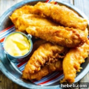 Irresistible Crispy Chicken Crispers, Chili's Style 5 Chicken Crispers in a metal serving dish with honey mustard.