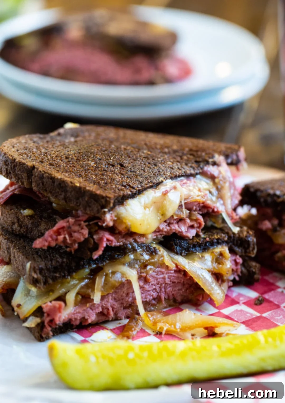 The Sizzling Corned Beef Melt 4 A Corned Beef Grilled Cheese sandwich cut in half, showcasing the gooey cheese and filling.