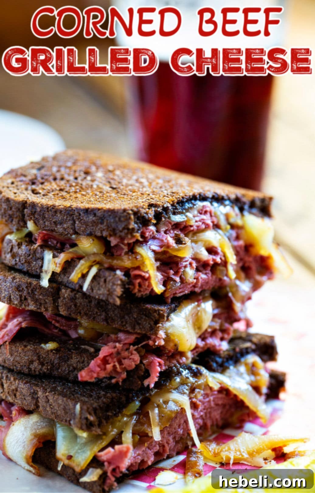 The Sizzling Corned Beef Melt 6 Stack of two grilled cheese sandwich halves.