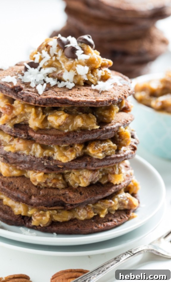Decadent German Chocolate Pancakes 4 A stack of German Chocolate Pancakes from a top-down view, highlighting the generous layers of chocolate pancakes and the sweet coconut-pecan syrup.