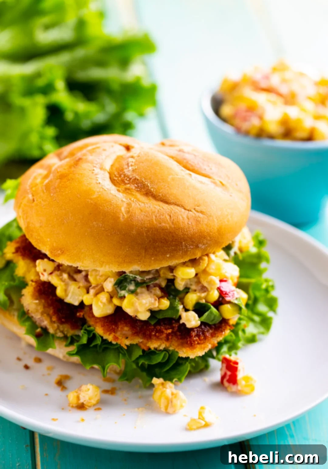 Hoosier Pork Tenderloin Sandwich 3 A close-up of a golden-fried pork tenderloin sandwich on a soft bun, ready to be served.