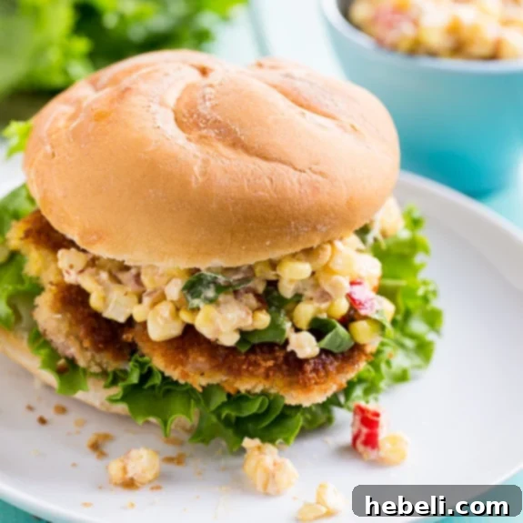 Hoosier Pork Tenderloin Sandwich 4 Two Indiana Pork Tenderloin Sandwiches, one with a side of creamy corn relish and another garnished with fresh parsley.