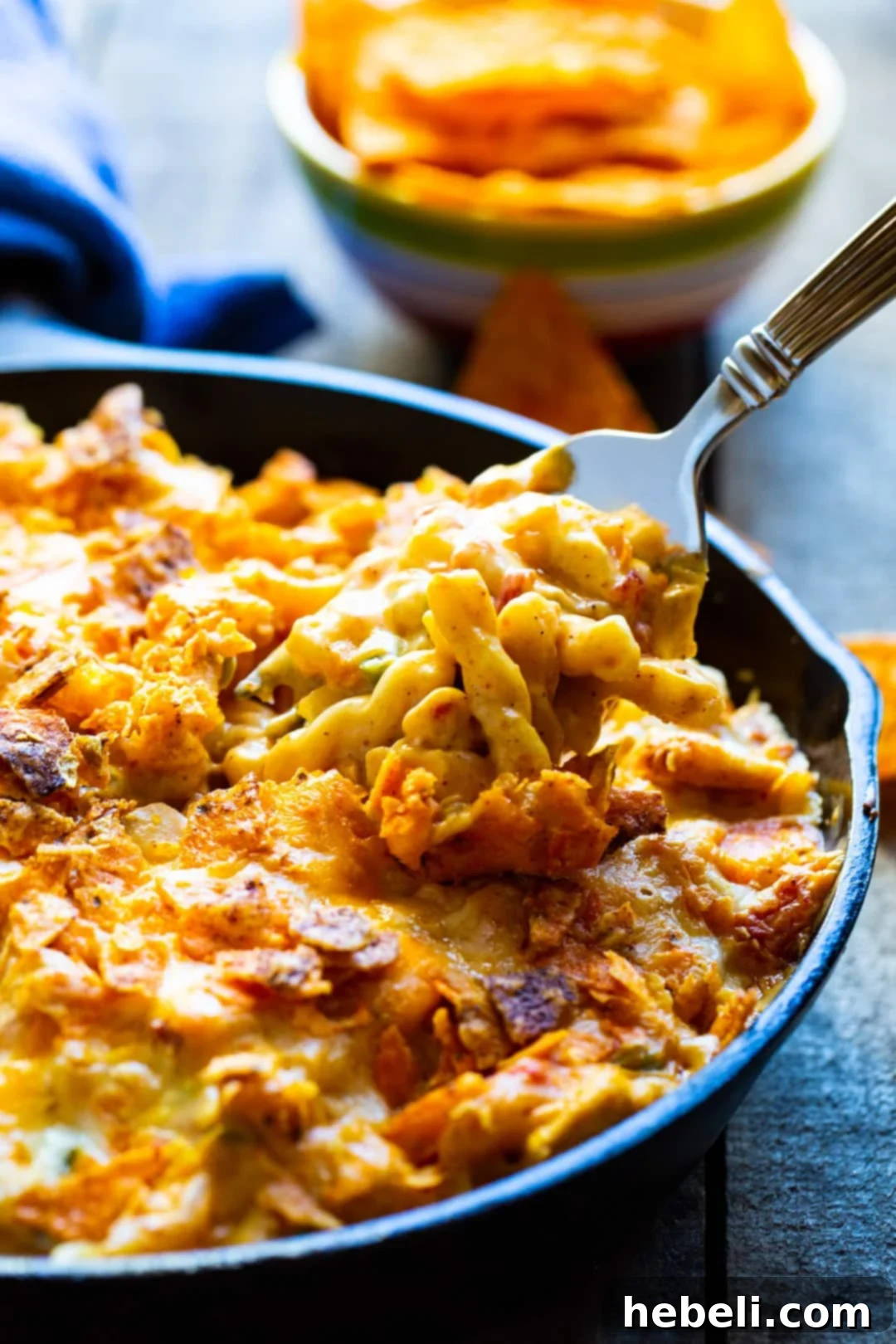 Hearty King Ranch Mac and Cheese 3 A fork lifts a generous, cheesy bite of King Ranch Mac and Cheese from the cast iron pan, showcasing its creamy texture.